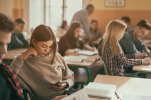 Female high school student using smart phone